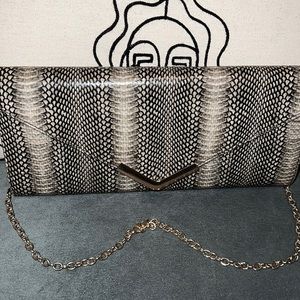 Faux snake skin purse with gold chain handle.